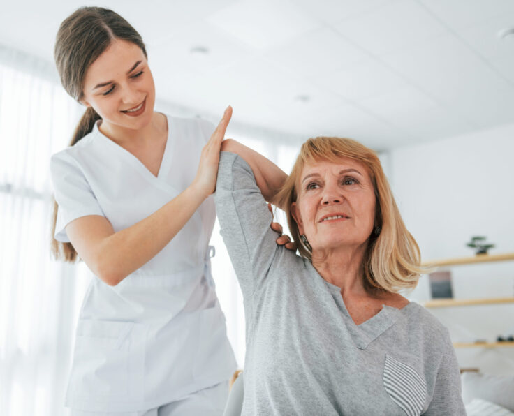 Working with hand. Senior woman is visiting physician in the office.